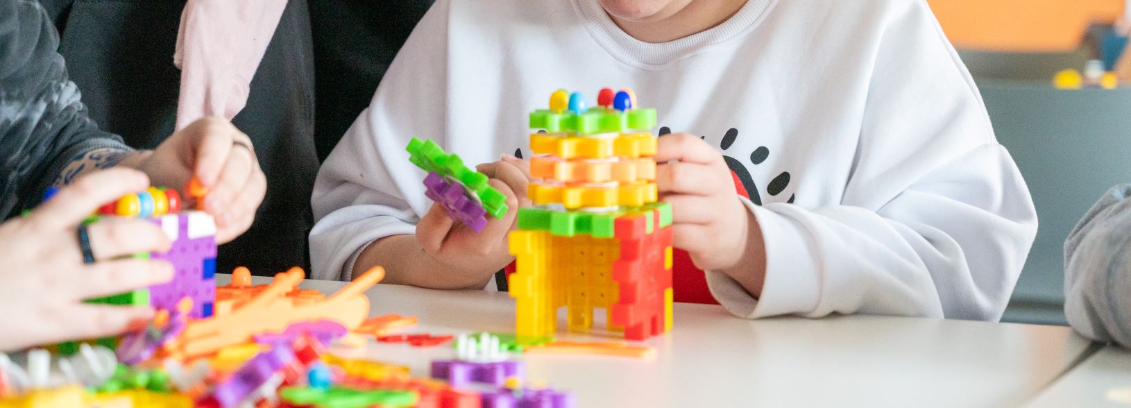 student playing with building bricks