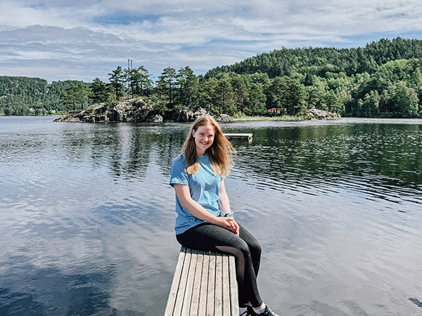 Woman sitting by a loch