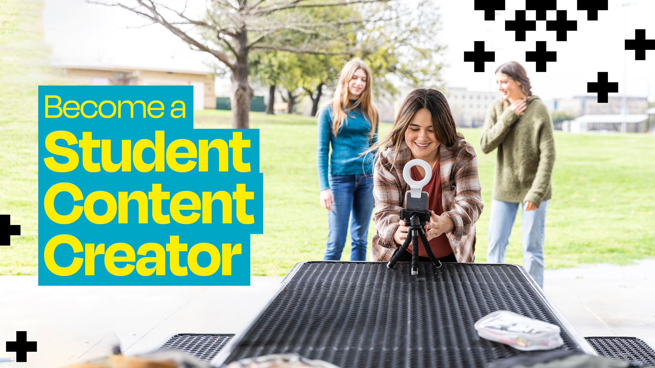 Group of 3 students outside creating content with a tripod and ring light. Yellow text on a blue background that reads Group of 3 students outside creating content with a tripod and ring light. Yellow text on a blue background that reads