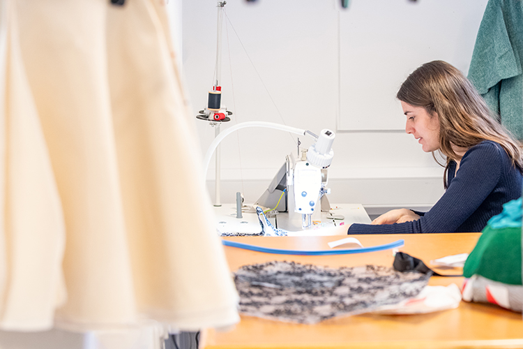 fashion student working on sewing machine