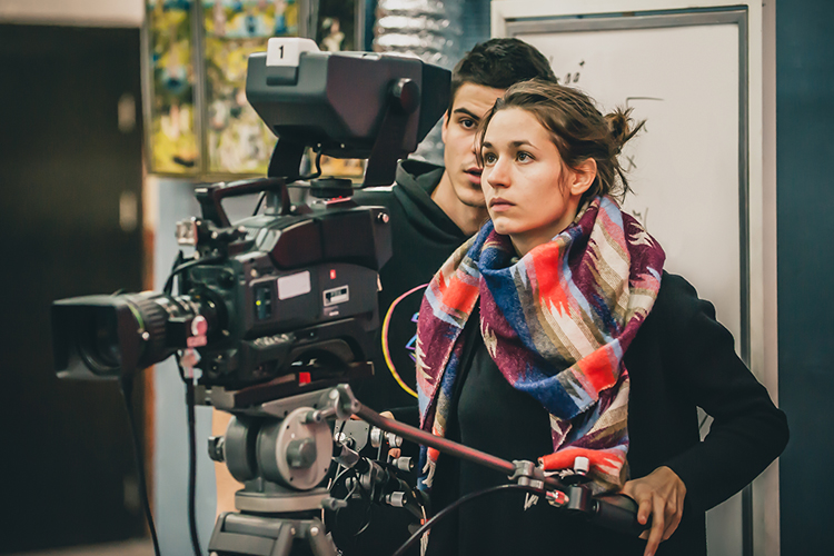 student holding camera