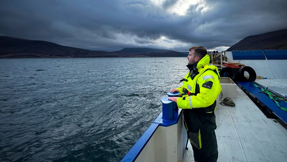 Modern Apprentice Andrew Logan looking out at sea from the deck of a vessel under a stormy sky. Modern Apprentice Andrew Logan looking out at sea from the deck of a vessel under a stormy sky.