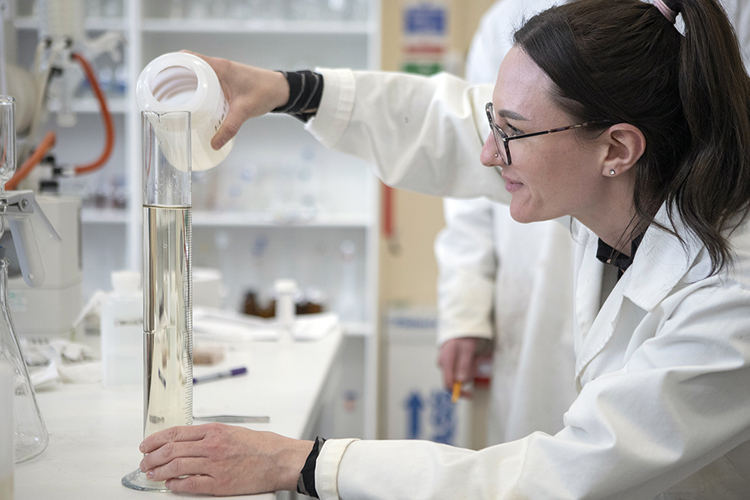 environmental science student analysing water samples in the lab