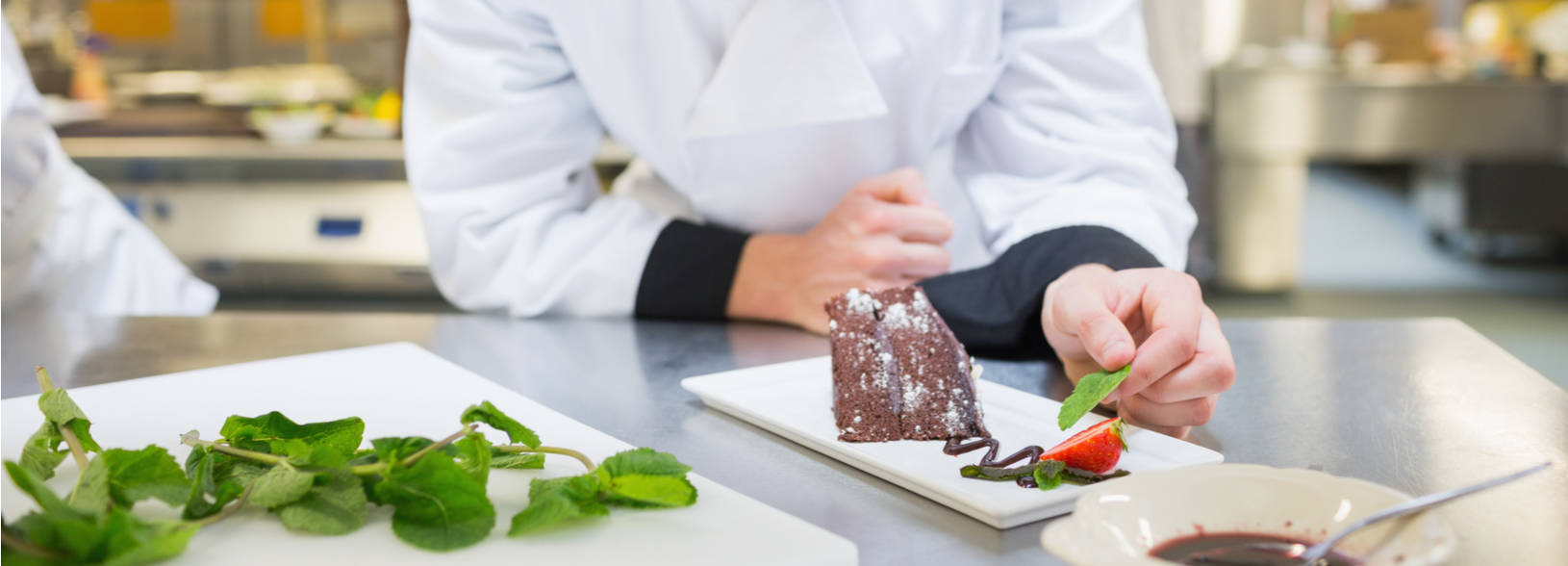 Student plating a dessert for service