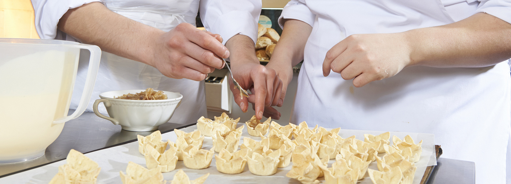 Two students filling canape cases